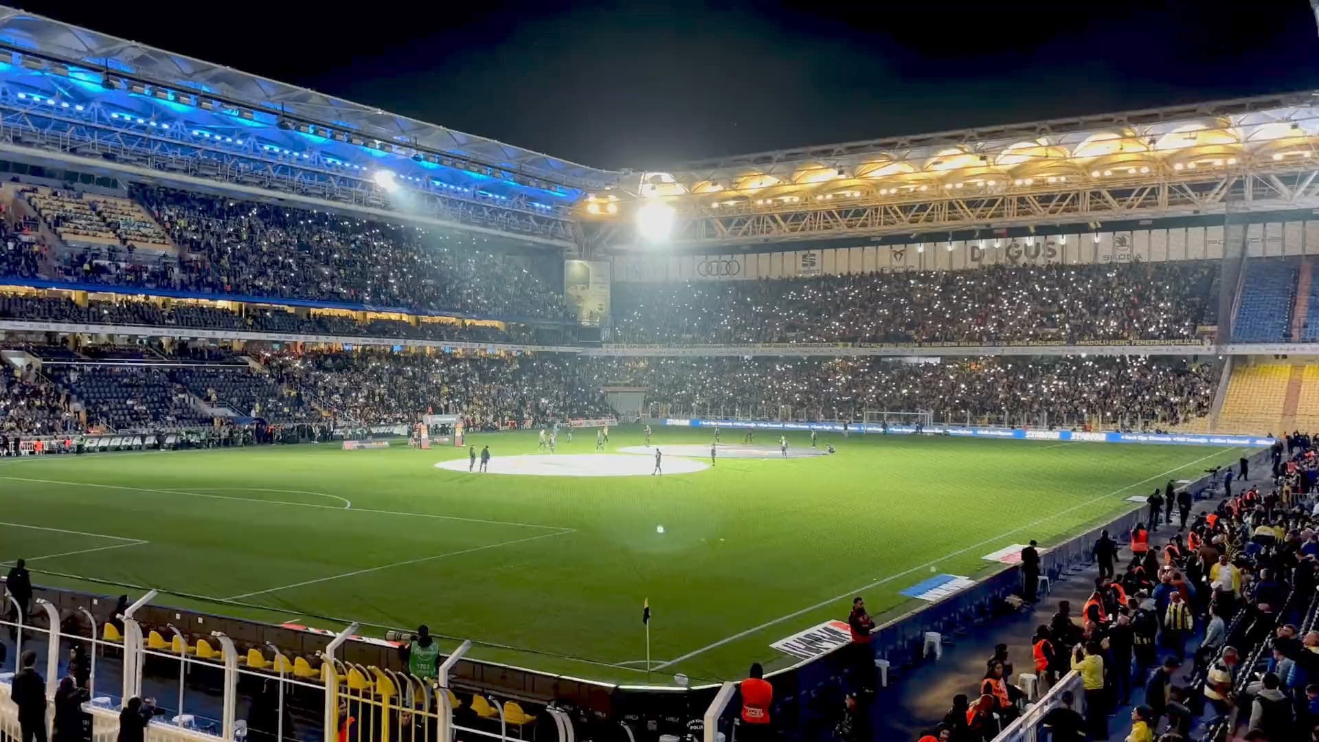 A packed stadium under floodlights on a match night
